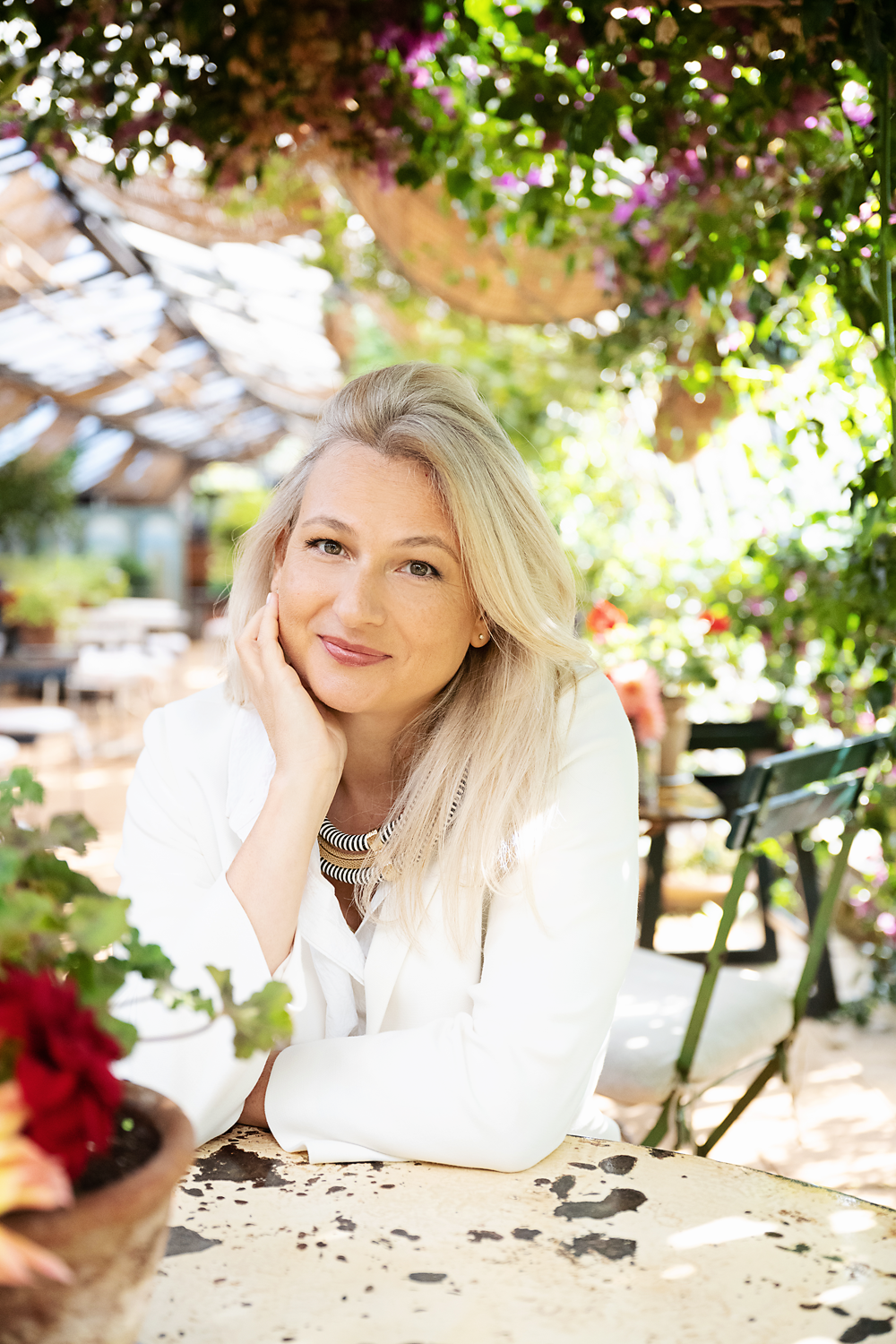 Elizabeth Adams resting at a garden cafe table