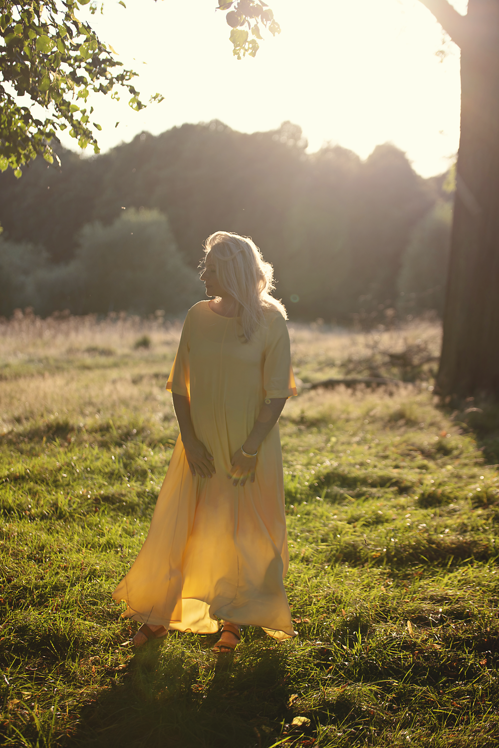 Elizabeth Adams walking in an open sunlit meadow